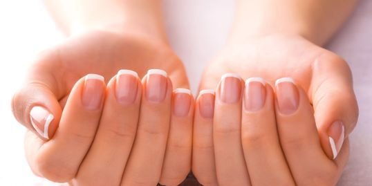 Close-up of a clean French manicure on natural nails